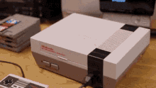 A GIF of loading a cartridge into an NES