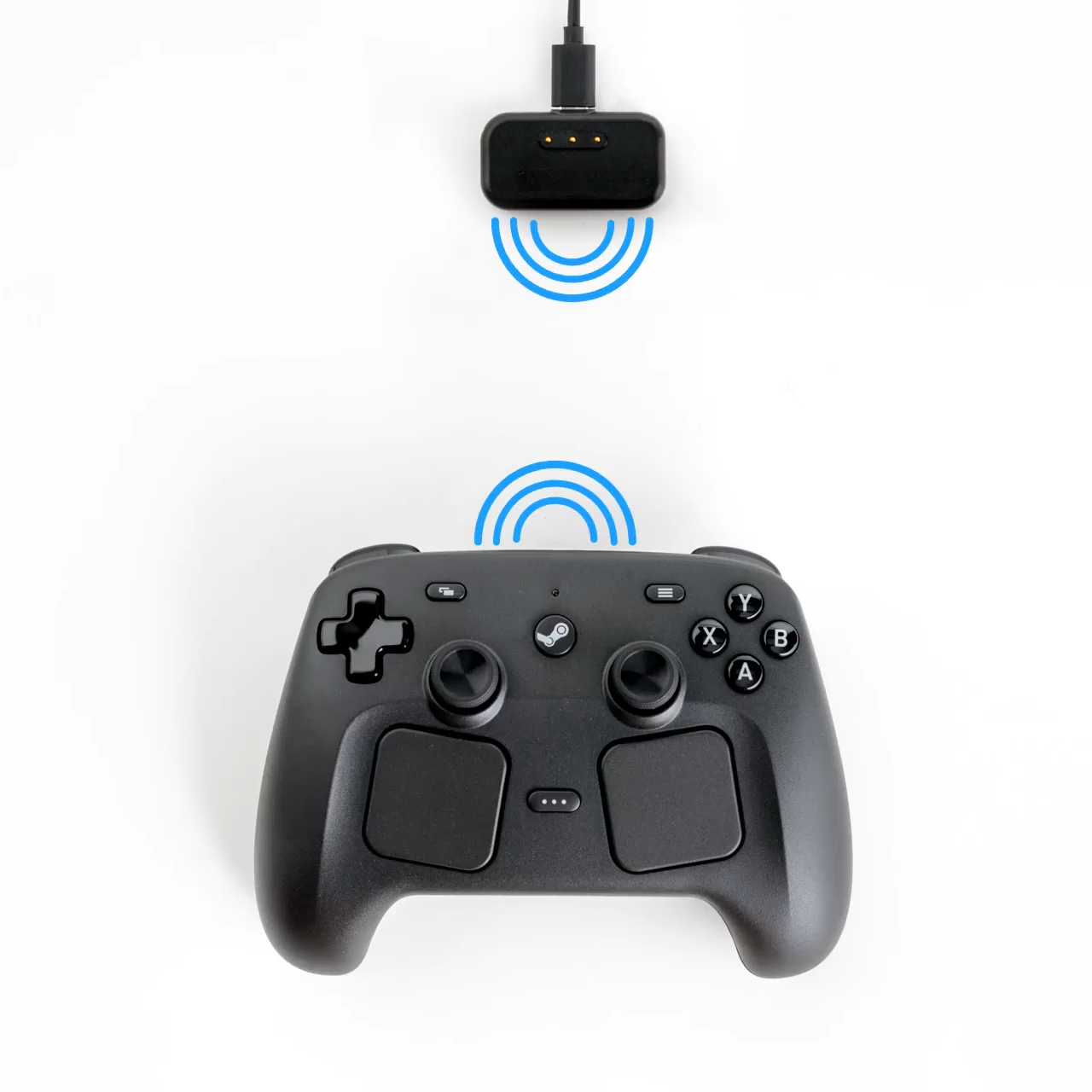 The new Steam Controller and it's charging/pairing "puck" dongle