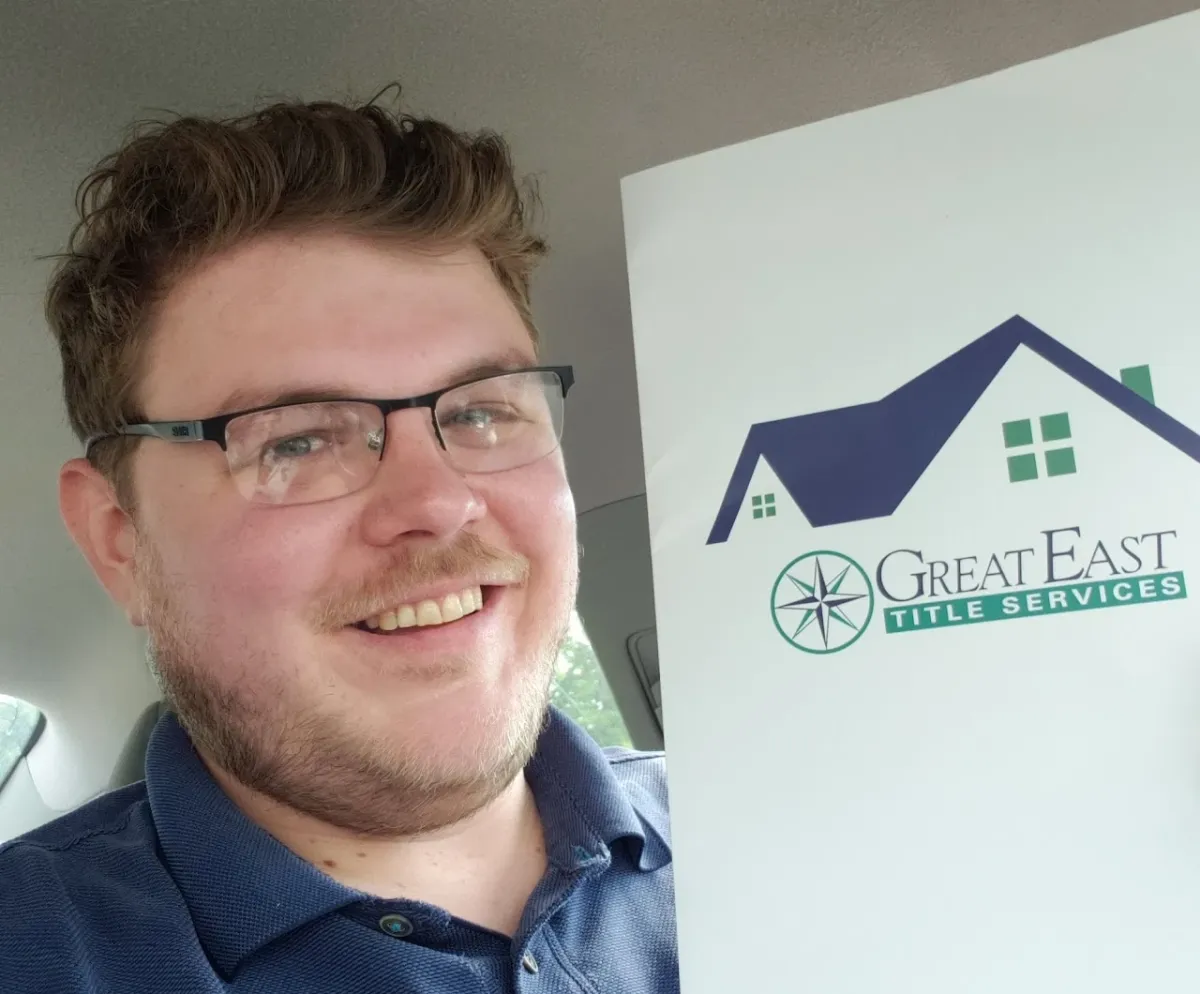 Gardiner Bryant holding a Great East Title Services folder on the day he bought his house